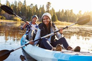African American Couple Rowing Kayak