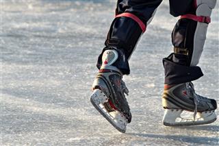 Skates On Player Feet During Ice Hockey