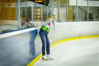 Beautiful Girl Skates On Ice Rink