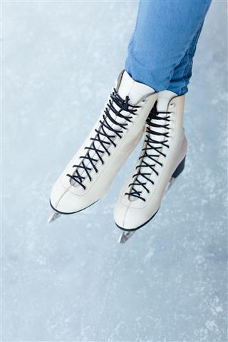 Woman Legs In White Ice Skates