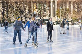 Young People Skating In Ice Rink