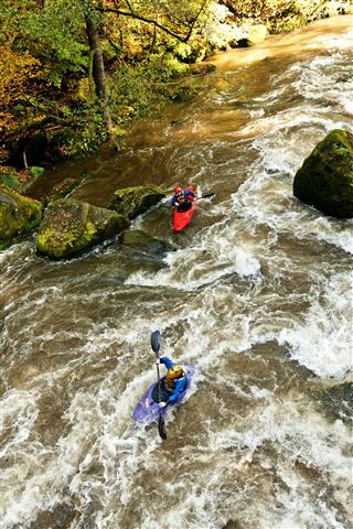 Kayakers On The Wild River