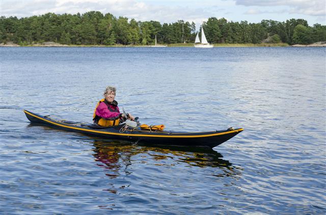 Mature woman paddling a kayak