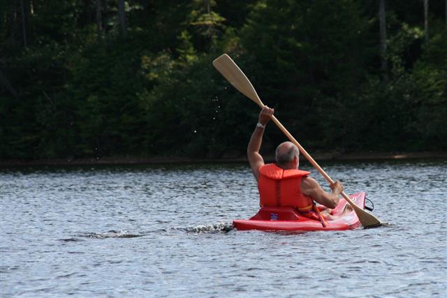 Senior Man Kayaking On Lake