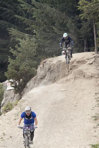 Mountain Bikers Racing Downhill