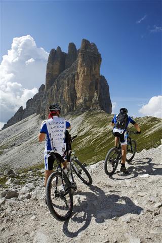 Cyclists In Scenic Mountain Landscape