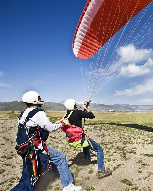 Father And Son Waiting For Paragliding