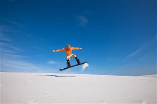 Snowboarder Is Flying Over The Sand Dune