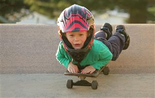 Boy Riding Laying On Skateboard