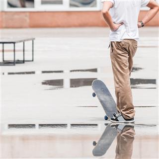 Skateboarder Standing And Thinking