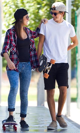 couple skateboarding on the street