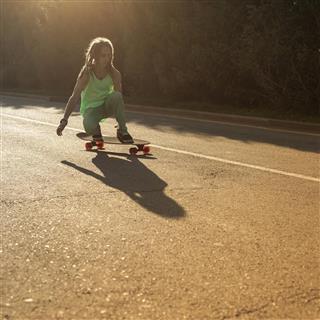 Teenager riding skateboard on a road