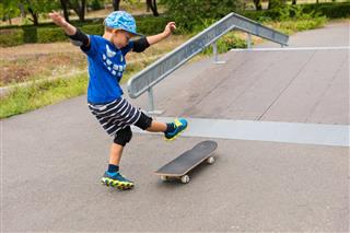 Young Boy Skateboarding near Ramp
