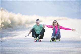 senior couple skateboarding