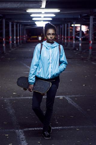Portrait Of Girl Holding Skateboard