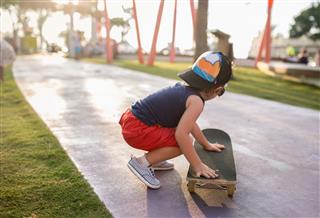 Little Boy Pushing Skateboard
