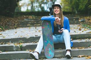woman with skateboard in park