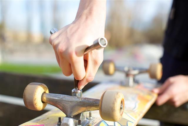 Skateboarder adjusting screws