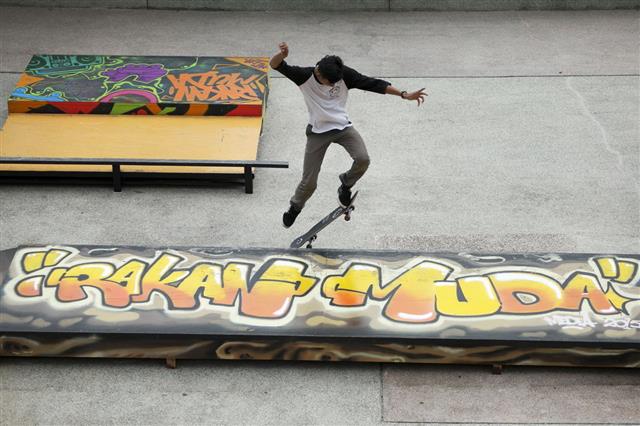 Skateboarder Skateboarding At Skatepark
