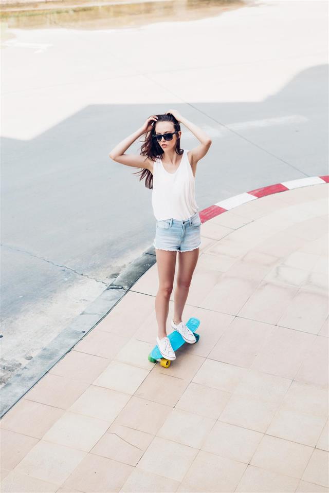 girl with skateboard on the street