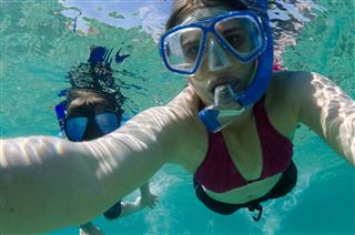Mom And Son Snorkeling Together In Hawaii