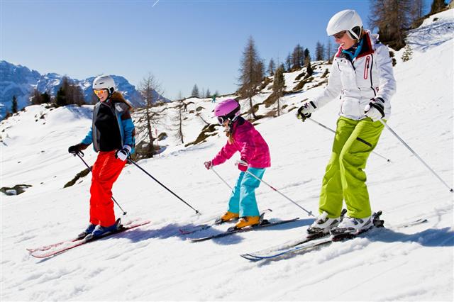 Ski Family In Mountains