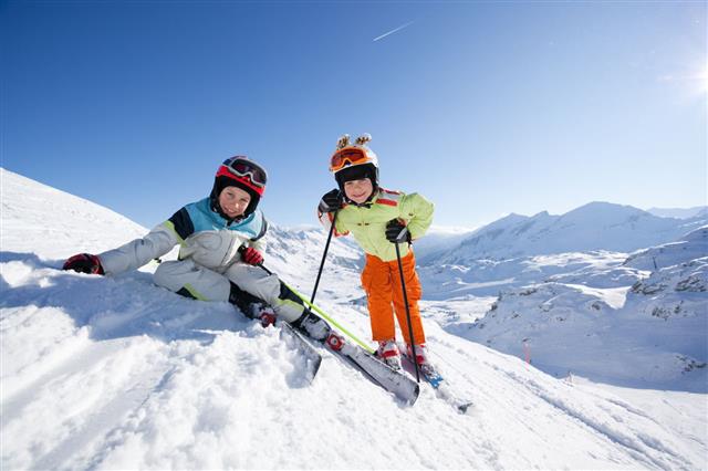 Happy Children In Skiing Outfit