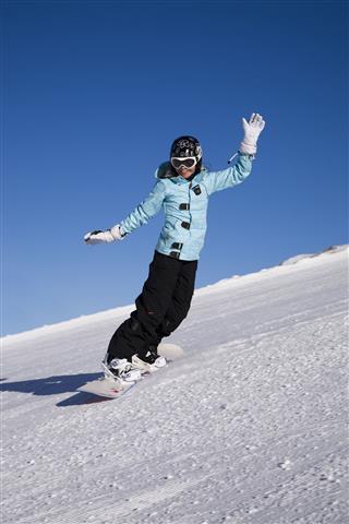 Young Woman On Snowboard