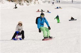 People Ride On The Snow Covered Slopes