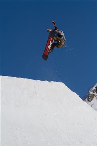 Snowboarder Jumps In Snow Park