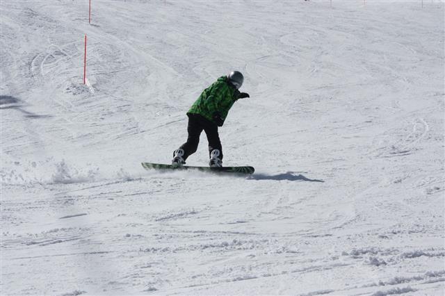 Young Snowboard Man Sliding Downhill