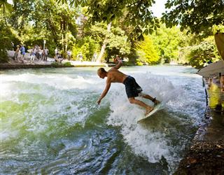 Man Surfing At The Eisbach River