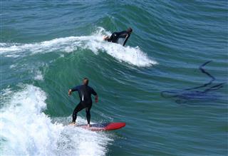 Pair Of Surfers On Wave