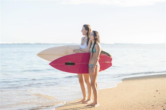 Mother And Daughter Going Surfing
