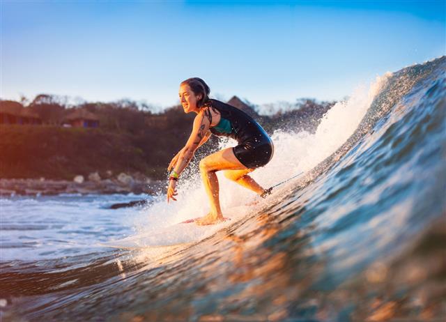 Surfer Girl Riding On Ocean Wave
