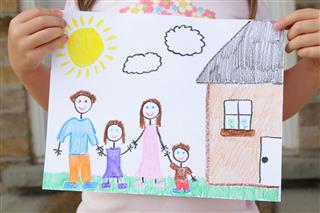 Girl Holds Drawing Of Her Family