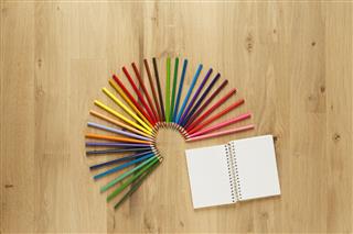 Colored Pencils On Wooden Floor