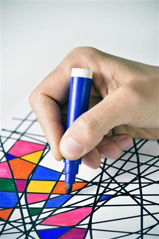 Man Coloring A Drawing