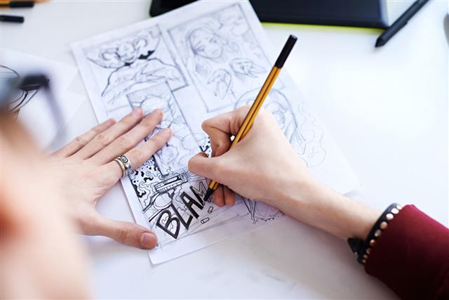 Male Hands Drawing The Comics