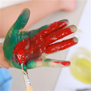 Little Boy Showing Hands Painted In Colors