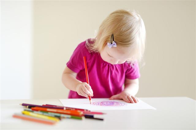 Girl Drawing With Colorful Pencils