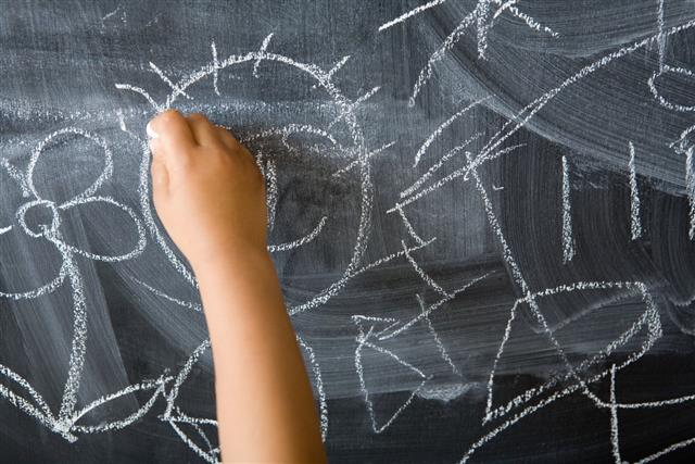 Child Drawing On Blackboard