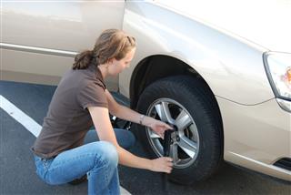 Woman Changing A Tire