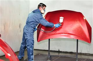 Worker Painting A Red Bonnet