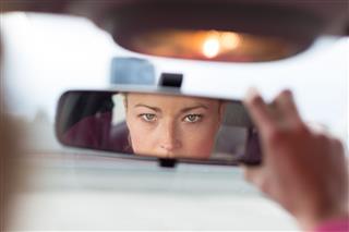 Lady Looking In Car Mirror