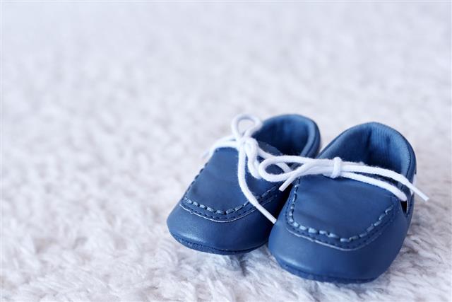Blue Baby Shoes On Carpet