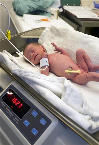 Newborn Baby Being Weighed