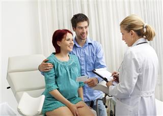 Gynecologist Talking To Pregnant Woman and her husband