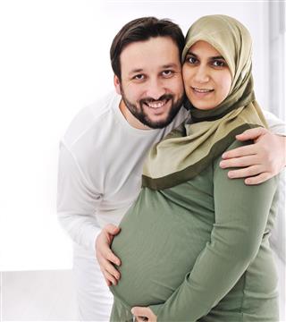 Happy young pregnant woman with her husband