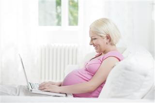 Pregnant woman with computer